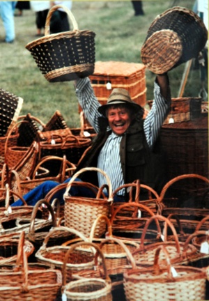 man surrounded by baskets